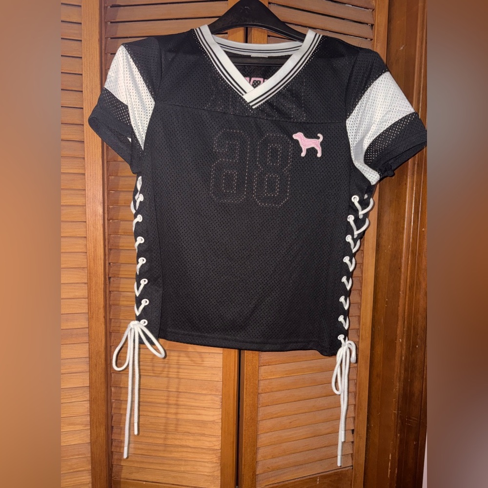 PINK lace up jersey.